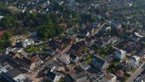 High-aerial-view-of-residential-area-houses-in-Scharbeutz,-Germany,-forward,-tilt-up-reveal-amazing-countryside-landscape,-day